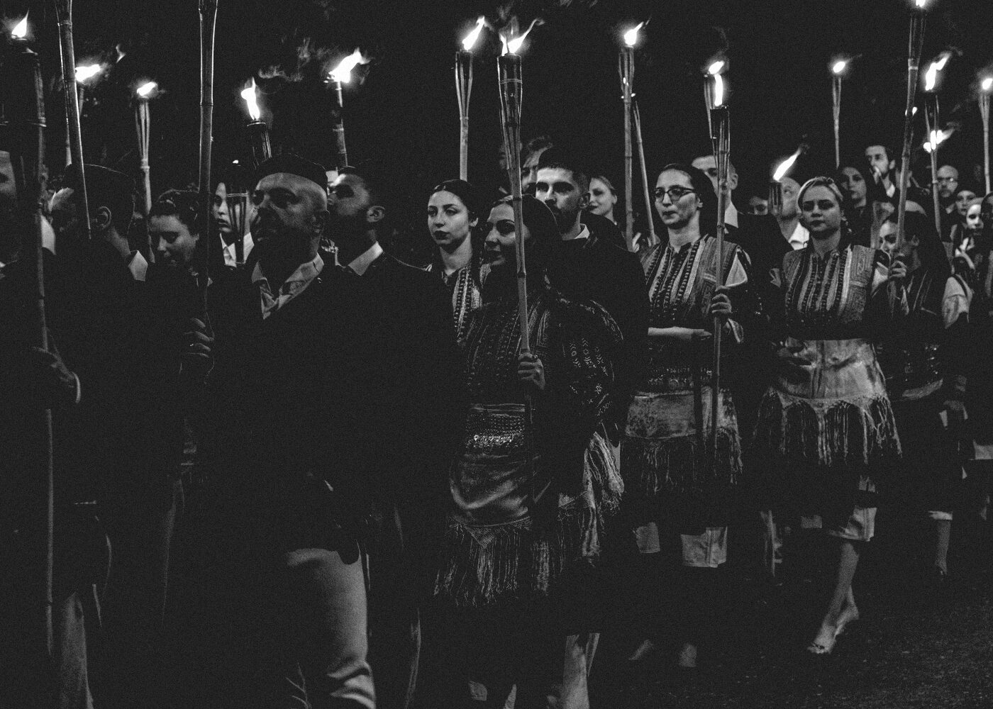 An outdoor reception under strings of lights at night