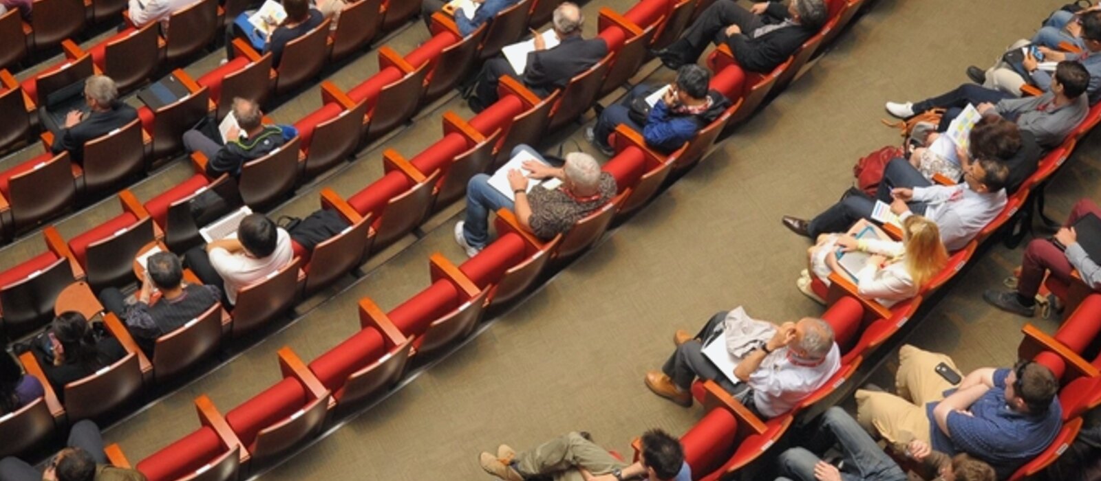 Delegations seated at a formal conference table beneath national flags