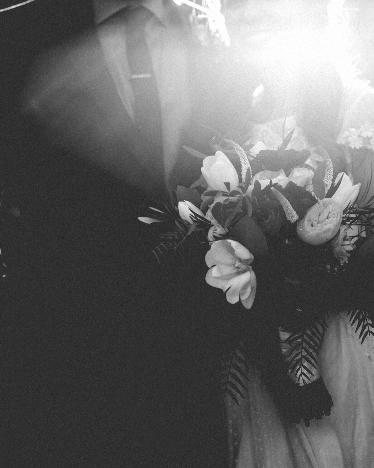 A bride and groom walking beneath a canopy of lights